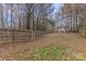 Expansive backyard featuring a wooden fence, lush trees, and a well-maintained lawn, perfect for outdoor activities at 3302 Cole Mill Rd, Charlotte, NC 28270