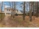 Wide backyard with a long fence for privacy, tall trees, and a view of the back of the house at 3302 Cole Mill Rd, Charlotte, NC 28270