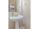 Bathroom with a pedestal sink, gold fixtures, and overhead storage at 3302 Cole Mill Rd, Charlotte, NC 28270