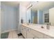 Bright bathroom featuring double sinks, a large mirror and neutral ceramic tile floors at 3302 Cole Mill Rd, Charlotte, NC 28270