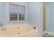 Relaxing bathroom featuring a jacuzzi tub and separate shower at 3302 Cole Mill Rd, Charlotte, NC 28270