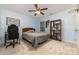 Bedroom with gaming chair and desk, bed, and wood bookcase at 3302 Cole Mill Rd, Charlotte, NC 28270