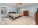 Spacious bedroom with large windows, ceiling fan and plush neutral carpeting at 3302 Cole Mill Rd, Charlotte, NC 28270