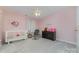 Cozy pink bedroom featuring a white crib, chair, dresser and ceiling fan at 3302 Cole Mill Rd, Charlotte, NC 28270