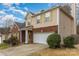 A charming home with a brick accent, a well-manicured lawn, and a convenient two-car attached garage at 3302 Cole Mill Rd, Charlotte, NC 28270