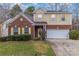 Charming two-story home featuring a brick facade, light yellow shutters, and a well-maintained front yard at 3302 Cole Mill Rd, Charlotte, NC 28270