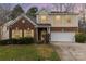 Charming two-story home featuring a brick facade, light yellow shutters, and a well-maintained front yard at 3302 Cole Mill Rd, Charlotte, NC 28270