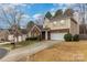 A charming home with a brick accent, a well-manicured lawn, and a convenient two-car attached garage at 3302 Cole Mill Rd, Charlotte, NC 28270