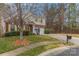 Well-maintained home with a lush lawn, mature trees, and a long driveway leading to an attached two-car garage at 3302 Cole Mill Rd, Charlotte, NC 28270