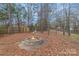 Backyard with a stone fire pit and space for outdoor relaxation and for the to play at 3302 Cole Mill Rd, Charlotte, NC 28270