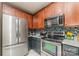 Close-up of the updated kitchen featuring stainless steel appliances and ample storage space at 3302 Cole Mill Rd, Charlotte, NC 28270