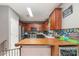 Well-lit kitchen featuring dark cabinets, stainless steel appliances, and stylish backsplash at 3302 Cole Mill Rd, Charlotte, NC 28270