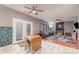 Open concept living room featuring fireplace, ceiling fans, and access to outdoor patio at 3302 Cole Mill Rd, Charlotte, NC 28270