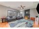 Well-lit living room with comfortable seating, a fireplace, and a ceiling fan at 3302 Cole Mill Rd, Charlotte, NC 28270