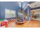 Play room with high ceilings, wooden staircase, and access to the kitchen at 3302 Cole Mill Rd, Charlotte, NC 28270