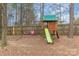 Wooden playground with a slide and swings, nestled in a backyard setting at 3302 Cole Mill Rd, Charlotte, NC 28270