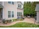 Lush backyard with a stone patio, perfect for outdoor gatherings and relaxation with mature landscaping at 375 Montibello Dr, Mooresville, NC 28117