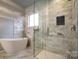 Bright bathroom features freestanding tub, walk-in shower, and sleek tile work at 375 Montibello Dr, Mooresville, NC 28117