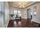 The bright formal dining room with chair railing boasts dark hardwood flooring, a modern chandelier, and large bright windows at 375 Montibello Dr, Mooresville, NC 28117