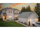 A spacious home exterior showcases a well-maintained yard, brick pathway, and detached garage with parking space at 375 Montibello Dr, Mooresville, NC 28117