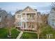 Charming two-story home with a welcoming front porch and second story balcony, surrounded by manicured lawns at 375 Montibello Dr, Mooresville, NC 28117