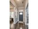 Inviting home foyer featuring rich hardwood floors, paneled walls and a stylish front door with decorative glass at 375 Montibello Dr, Mooresville, NC 28117
