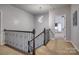 Bright hallway with decorative railing and modern light fixture at 375 Montibello Dr, Mooresville, NC 28117