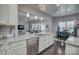 Open-concept kitchen with island, stainless steel dishwasher, and seamless view into the dining and living areas at 375 Montibello Dr, Mooresville, NC 28117