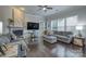 Inviting living room with hardwood floors, a fireplace, comfortable sofas, and large windows at 375 Montibello Dr, Mooresville, NC 28117