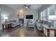 Comfortable living room featuring hardwood floors, a ceiling fan, a fireplace, and plenty of natural light at 375 Montibello Dr, Mooresville, NC 28117