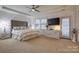 Spacious main bedroom with a tray ceiling, carpeted floor, and a door leading to the outside at 375 Montibello Dr, Mooresville, NC 28117