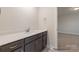 Modern bathroom featuring a vanity with gray cabinets, light countertop, and ample storage space at 4021 Harmattan Dr, Denver, NC 28037