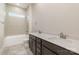 Modern bathroom with a double vanity, gray tile flooring, and a combined tub and shower at 4021 Harmattan Dr, Denver, NC 28037
