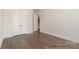 This bedroom has a large closet, hardwood floors, and neutral paint at 4021 Harmattan Dr, Denver, NC 28037