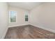 This bedroom has wood floors, neutral paint, and two windows at 4021 Harmattan Dr, Denver, NC 28037