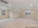 Bright bonus room featuring neutral carpeting, two windows, and ample space, perfect for versatile use at 4021 Harmattan Dr, Denver, NC 28037