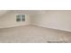 Spacious bonus room with neutral carpeting, a window, and versatile layout, great for various activities at 4021 Harmattan Dr, Denver, NC 28037