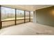 Spacious screened porch with wood railings, offering outdoor living space and views of backyard at 4021 Harmattan Dr, Denver, NC 28037