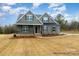 Charming two-story home with a covered front porch and beautifully landscaped front yard at 4021 Harmattan Dr, Denver, NC 28037