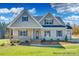 Charming home with a welcoming front porch, well-manicured lawn, and inviting curb appeal at 4021 Harmattan Dr, Denver, NC 28037