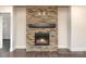 Stone fireplace with wood beam mantel and gas logs at 4021 Harmattan Dr, Denver, NC 28037