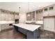 Modern kitchen with custom cabinets, stainless appliances, and large center island at 4021 Harmattan Dr, Denver, NC 28037