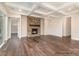 Open living room features a stone fireplace and hardwood floors at 4021 Harmattan Dr, Denver, NC 28037