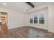 Bright living room featuring hardwood floors, large windows, and a rustic beam ceiling accent at 4021 Harmattan Dr, Denver, NC 28037