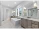 Bright bathroom featuring a soaking tub, dual vanities with marble countertops, and a separate walk-in shower at 722 Hillside Ave, Charlotte, NC 28209