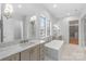 A sleek bathroom with a freestanding tub, marble countertops, and modern fixtures at 722 Hillside Ave, Charlotte, NC 28209