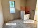 Dog bathing station and custom-built bench inside incomplete bathroom, and large window for natural light at 722 Hillside Ave, Charlotte, NC 28209