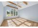 Inviting bedroom with large windows, wood beams, vaulted ceiling, and hardwood floors at 722 Hillside Ave, Charlotte, NC 28209