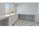 Functional laundry room with ample counter space, a sink, and stylish tile flooring at 722 Hillside Ave, Charlotte, NC 28209