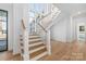 Staircase showcasing natural wood steps, white rails, and a view into an adjoining room at 722 Hillside Ave, Charlotte, NC 28209